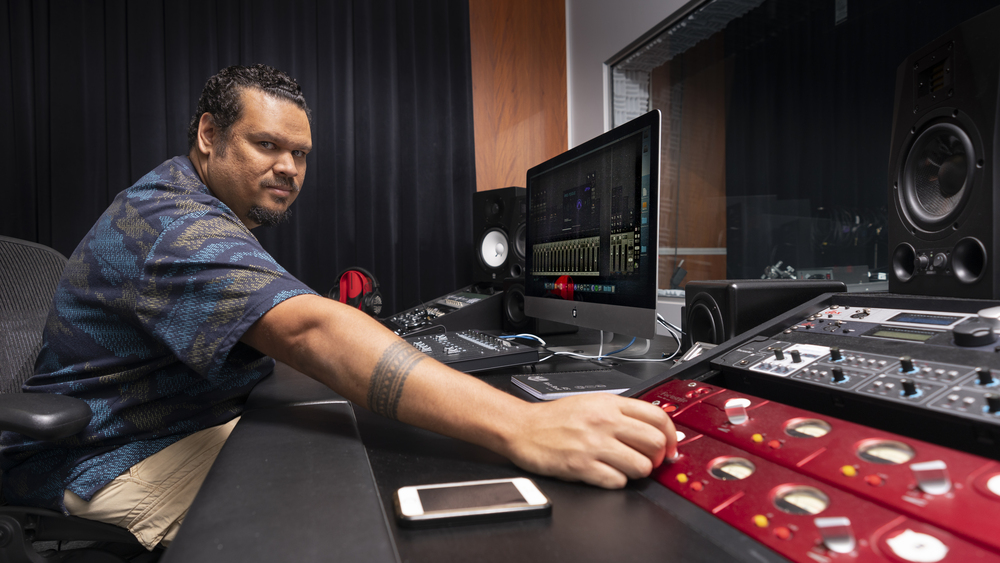 Will Kepa uses the control panel in the Yil Lull Recording Studio