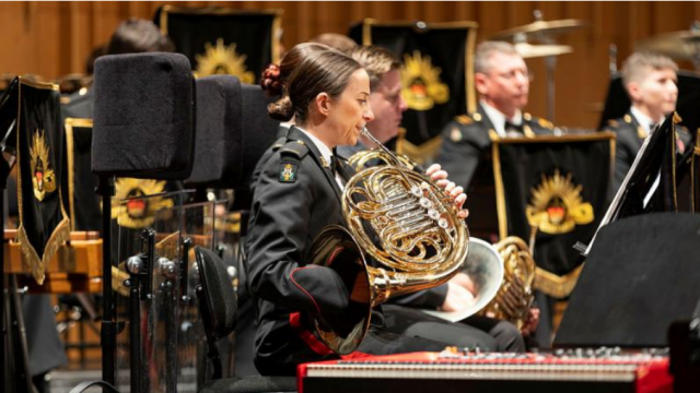 Army musician Sandra Miletic from the Band of the Royal Military College plays the French horn during a concert at Llewellyn Hall.